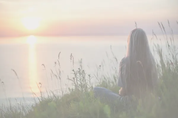 A peaceful individual practicing breathwork, symbolizing nervous system regulation and inner safety through gentle breathing techniques.
