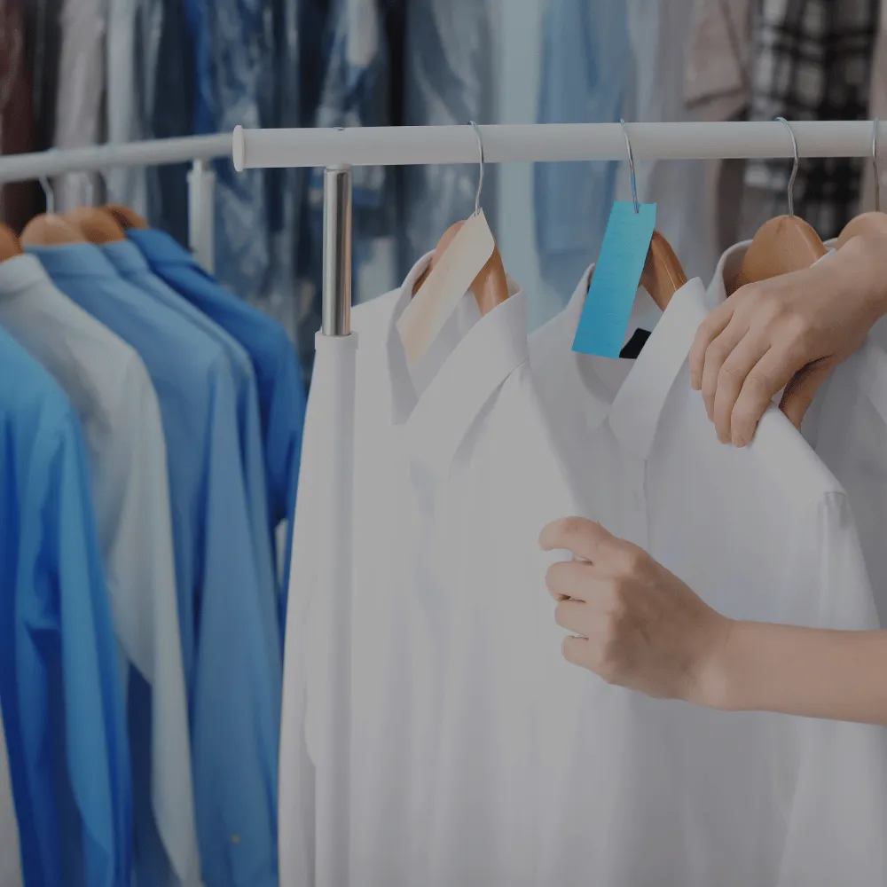 Dry cleaning clothing rack covered with blue tint and then a bright green question mark.