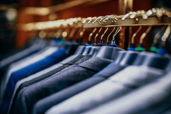 Expensive suits on a rack at a store. Suits are one of the most common dry cleaned items.