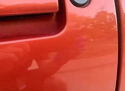 Auto detailer polishing a car to remove scratches and restore shine in Vancouver, WA