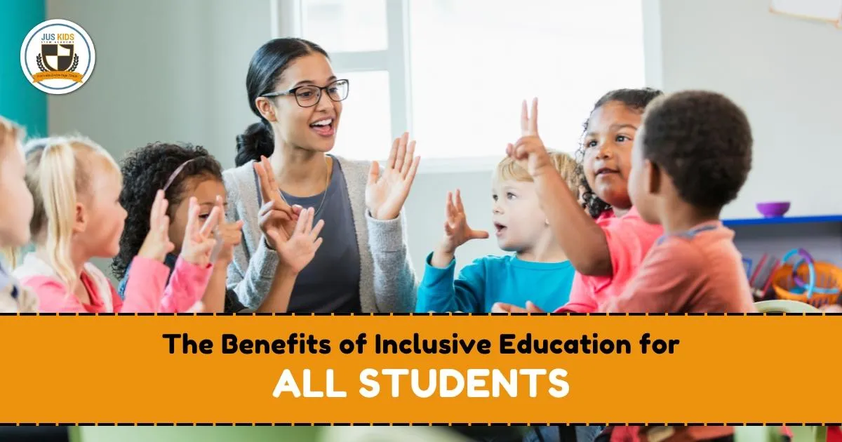 A diverse group of young children sit in a circle with their teacher, joyfully raising their hands and engaging in a classroom activity. Text overlay reads ‘The Benefits of Inclusive Education for All Students’ and the Jus Kids International School logo appears in the top left corner.