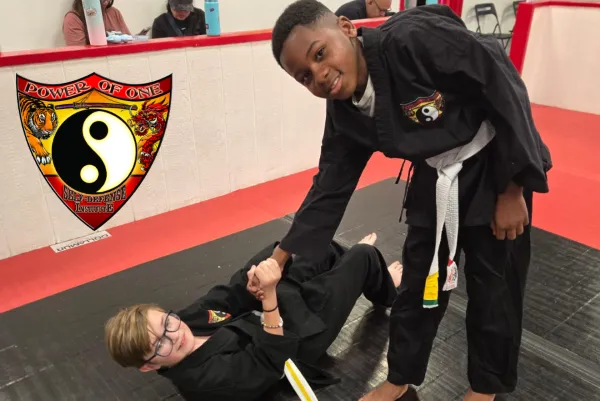 young man helps another young man