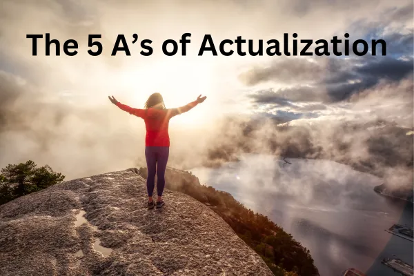 Woman at the peak of a mountain representing the 5 A's of Actualization