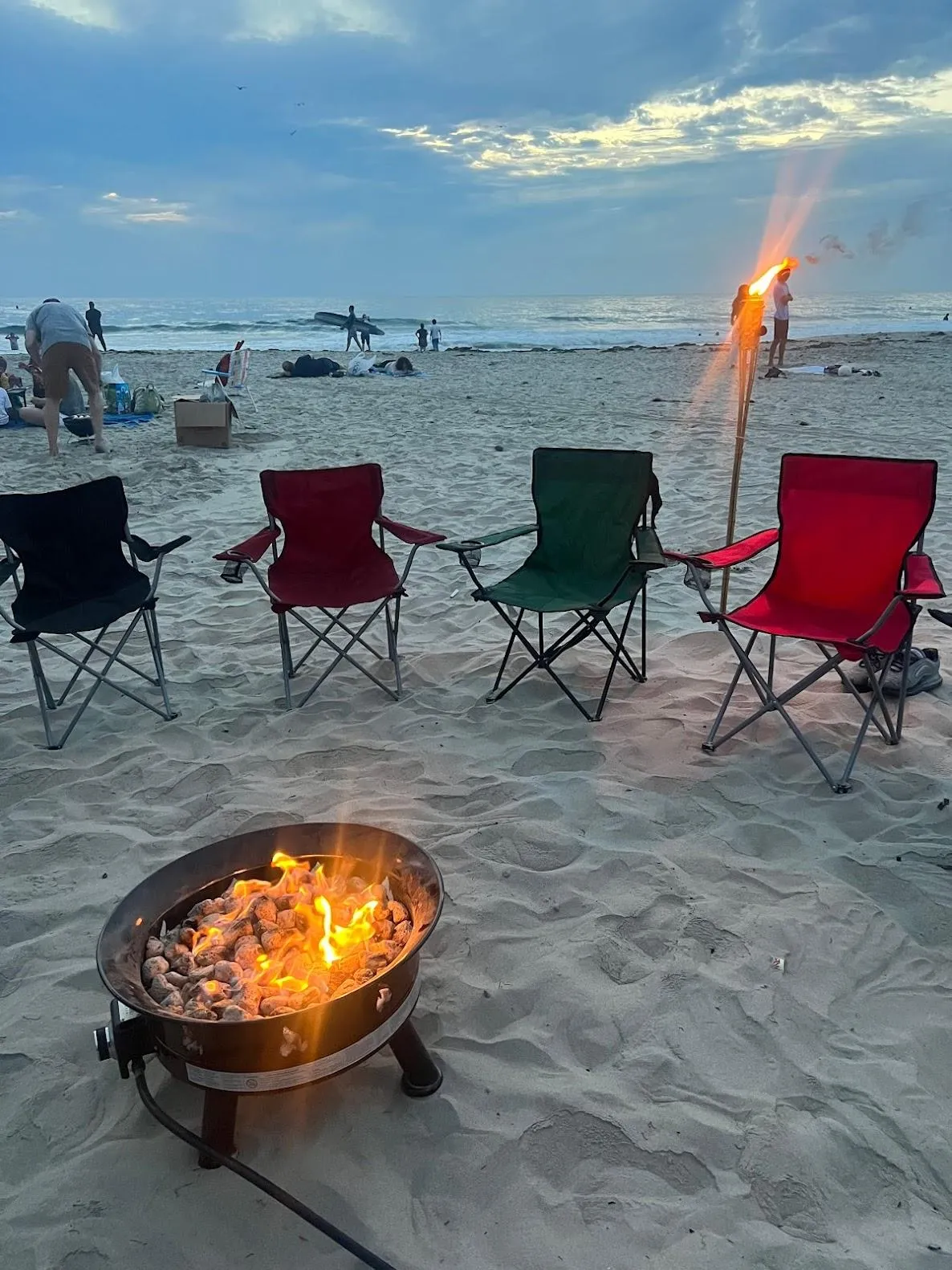 La Jolla bonfire with firepit, seating, tiki torches, and glow games.