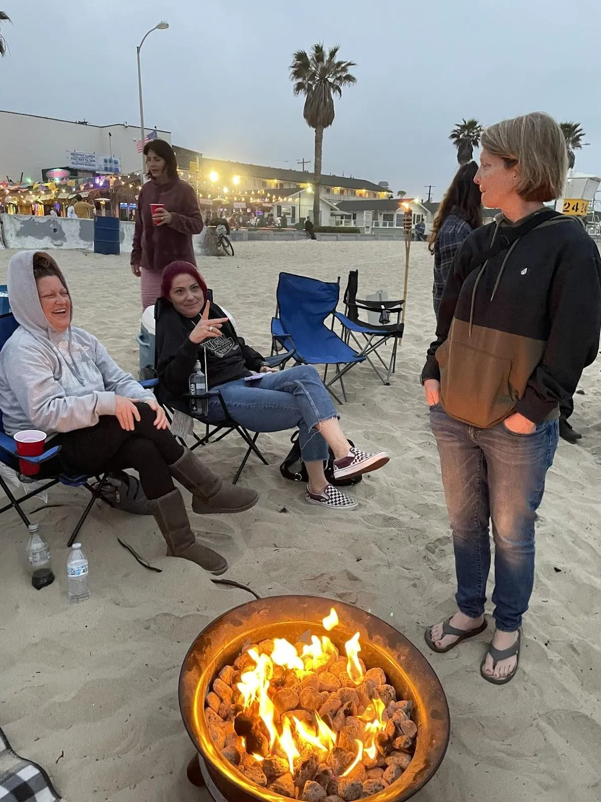 Pacific Beach bonfire setup with games and tikki torches