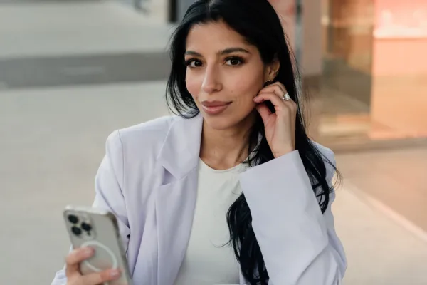 A picture of a woman holding her phone