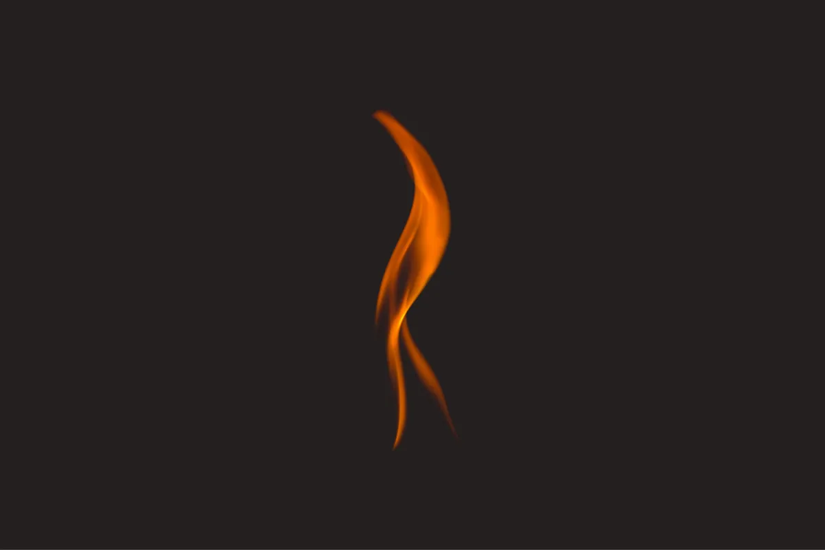 Solitary red and orange flame against an black background, symbolizing anger and rage