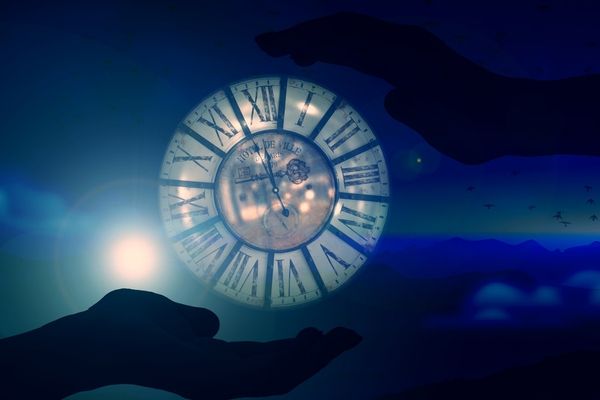 Hands-holding-a-cosmic-clock