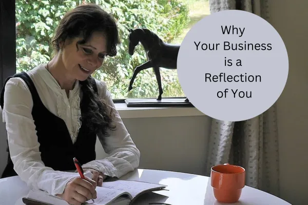 Liz at a desk writing in her diary