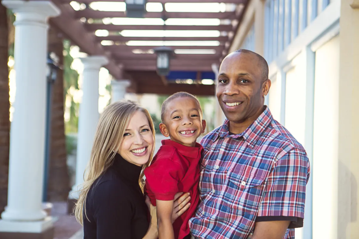 Lifestyle family photo at SanTan Village in Gilbert AZ with parents holding their young son.