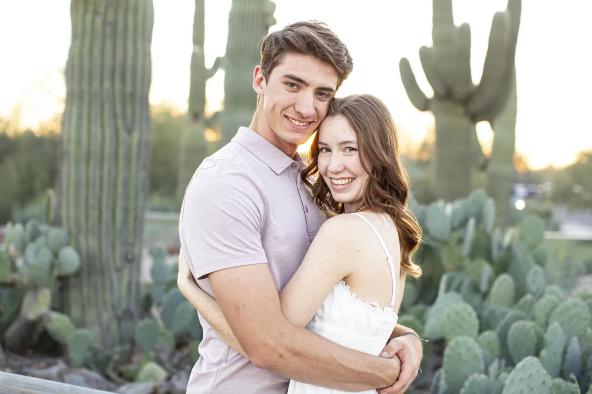 Couple posing together in the desert cactus landscape at the Riparian Preserve in Gilbert AZ.