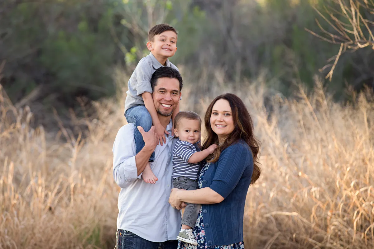 Family of four with young children during a natural, outdoor family photography session in Gilbert Arizona.