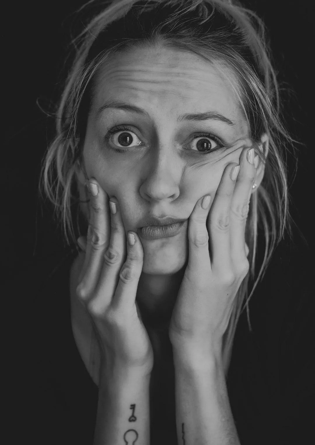 woman with head in hands looking confused
