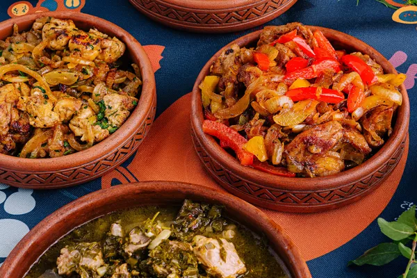 A vibrant display of colorful, nutritious African stews served in traditional bowls on a beautifully set table, showcasing a variety of fresh ingredients and rich cultural heritage.