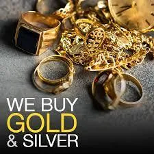 Stack of gold and silver coins next to a sign that says "We Buy Gold & Silver"