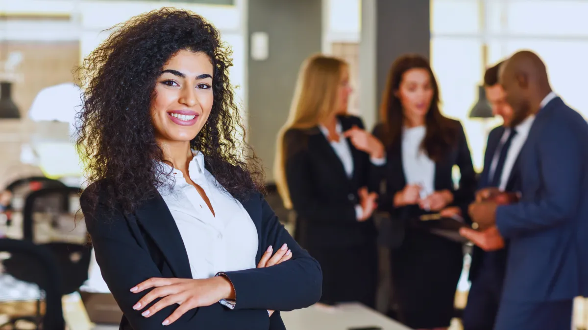 stock image| female standing with arms crossed in front of office
