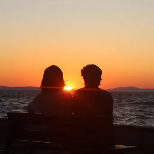 “A heart drawn in the sand with waves approaching, symbolizing love, impermanence, and emotional connection.”