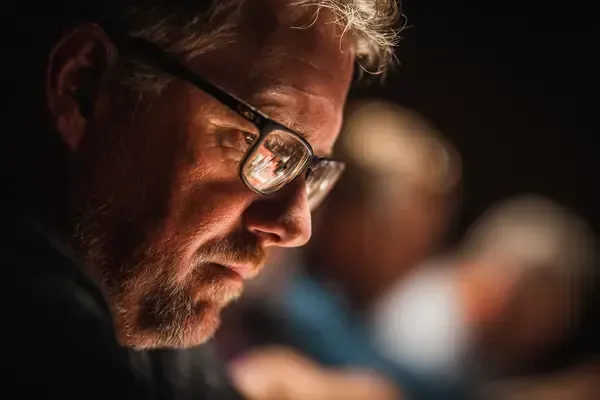 Professional bridge player demonstrating mental focus during tournament competition