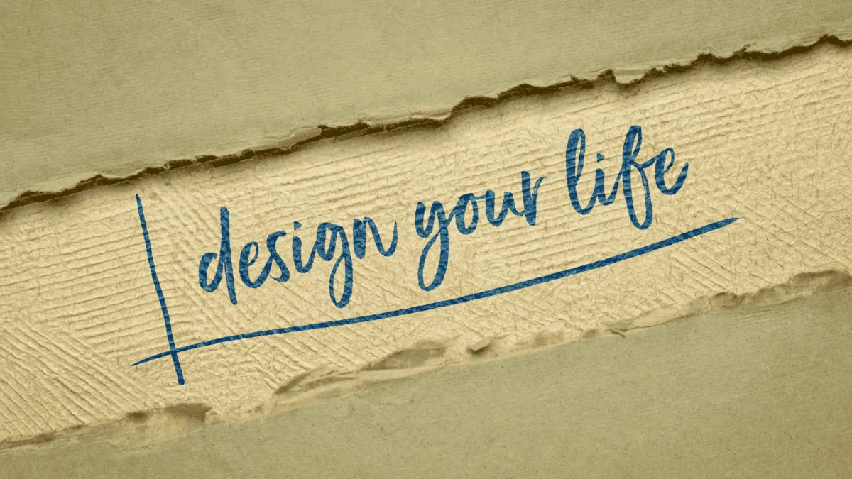 Brown paper wrapping with a section ripped away to reveal the words “Design your life”.