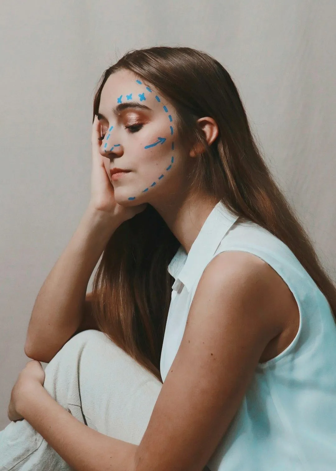 Lady with beautiful skin with her hand on her face