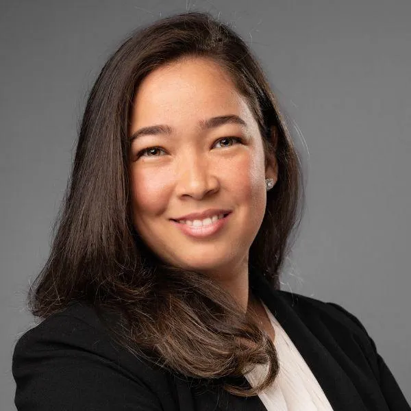 Professional headshot of a smiling Latina school teacher in professional attire, taken for a social profile