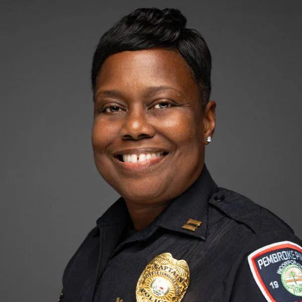 Official headshot of a Black female officer in uniform, smiling
