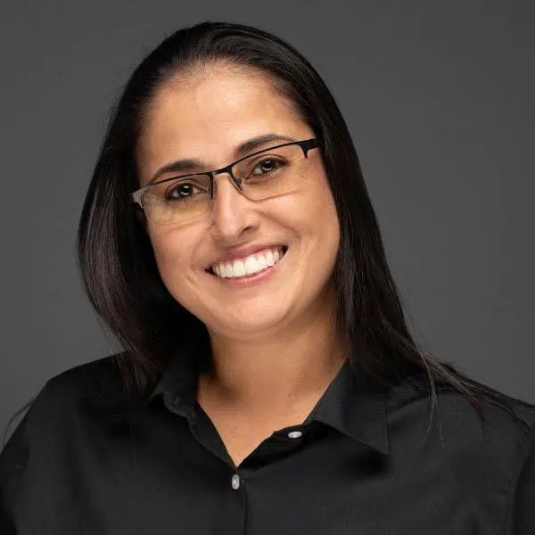 Professional headshot of a smiling Latina business professional DANIELLE AKAMINE in business attire, taken for a social profile