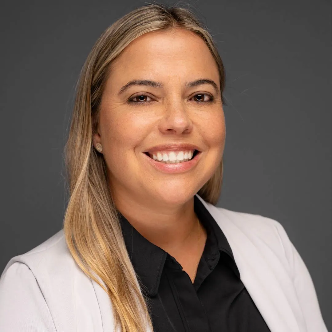 Professional headshot of a Latino officer Yvette Vazquez Bello in business attire, smiling for a corporate profile