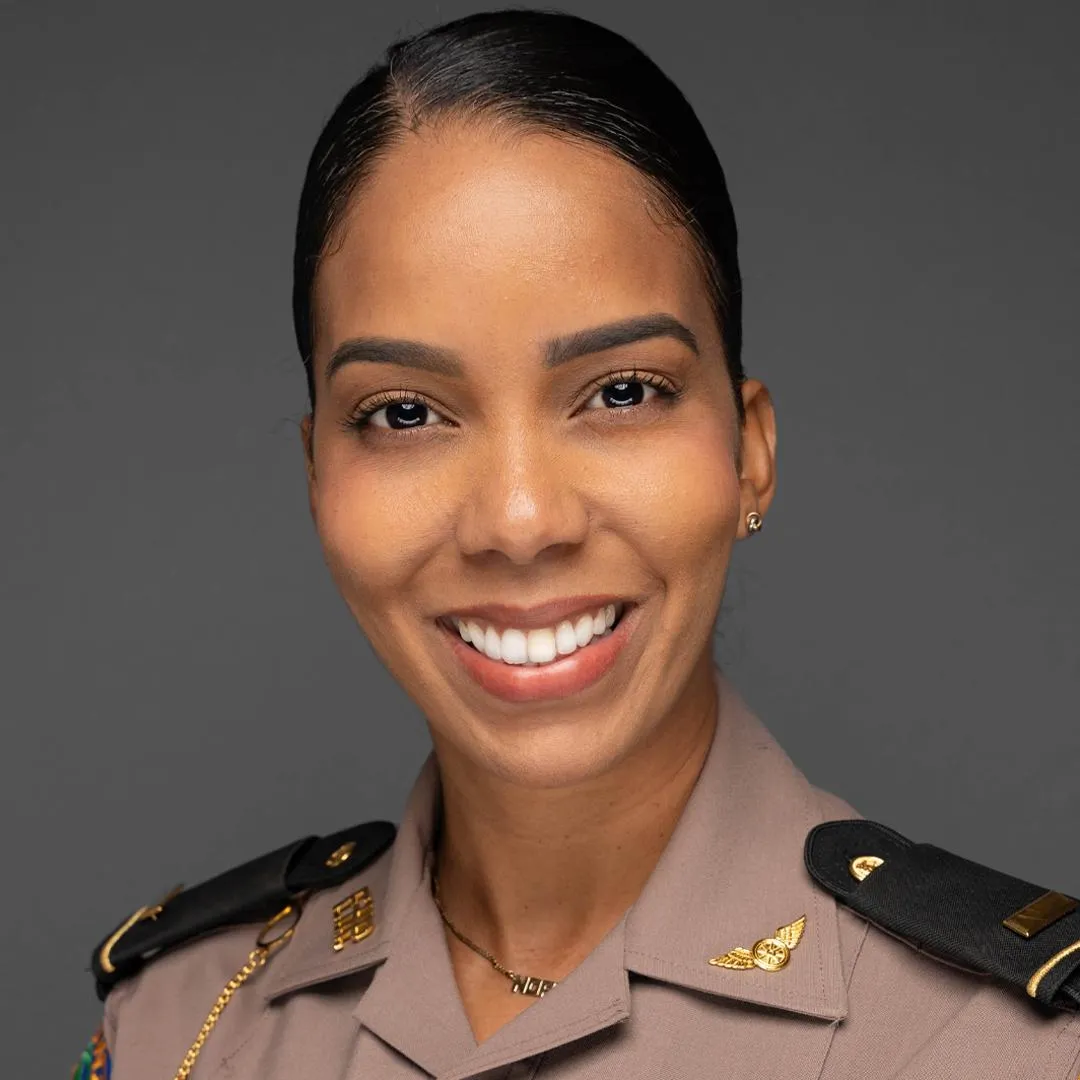Official headshot of a Black female officer in uniform, smiling