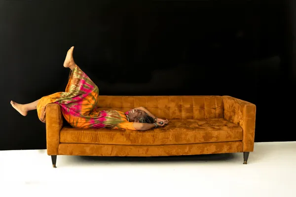 A woman full of joy relaxing on a couch