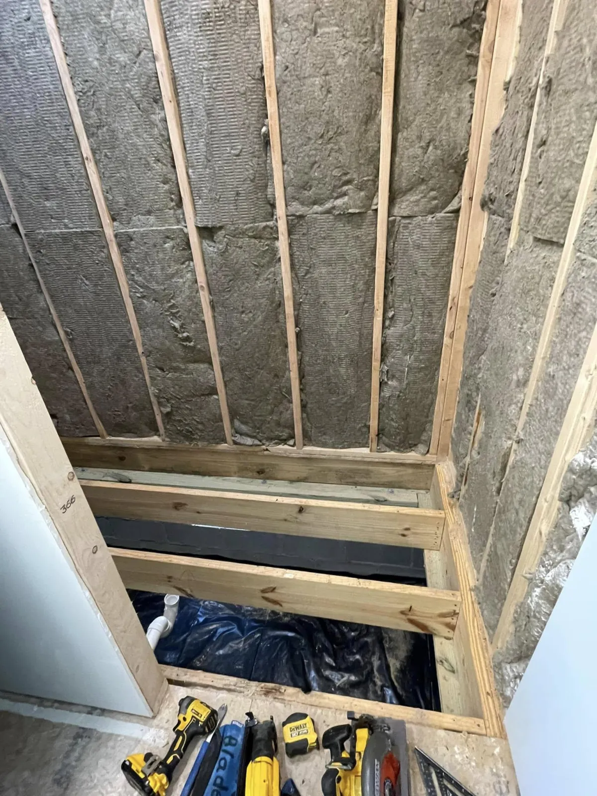 Wall studs and framing in progress during Columbia County bathroom buildout