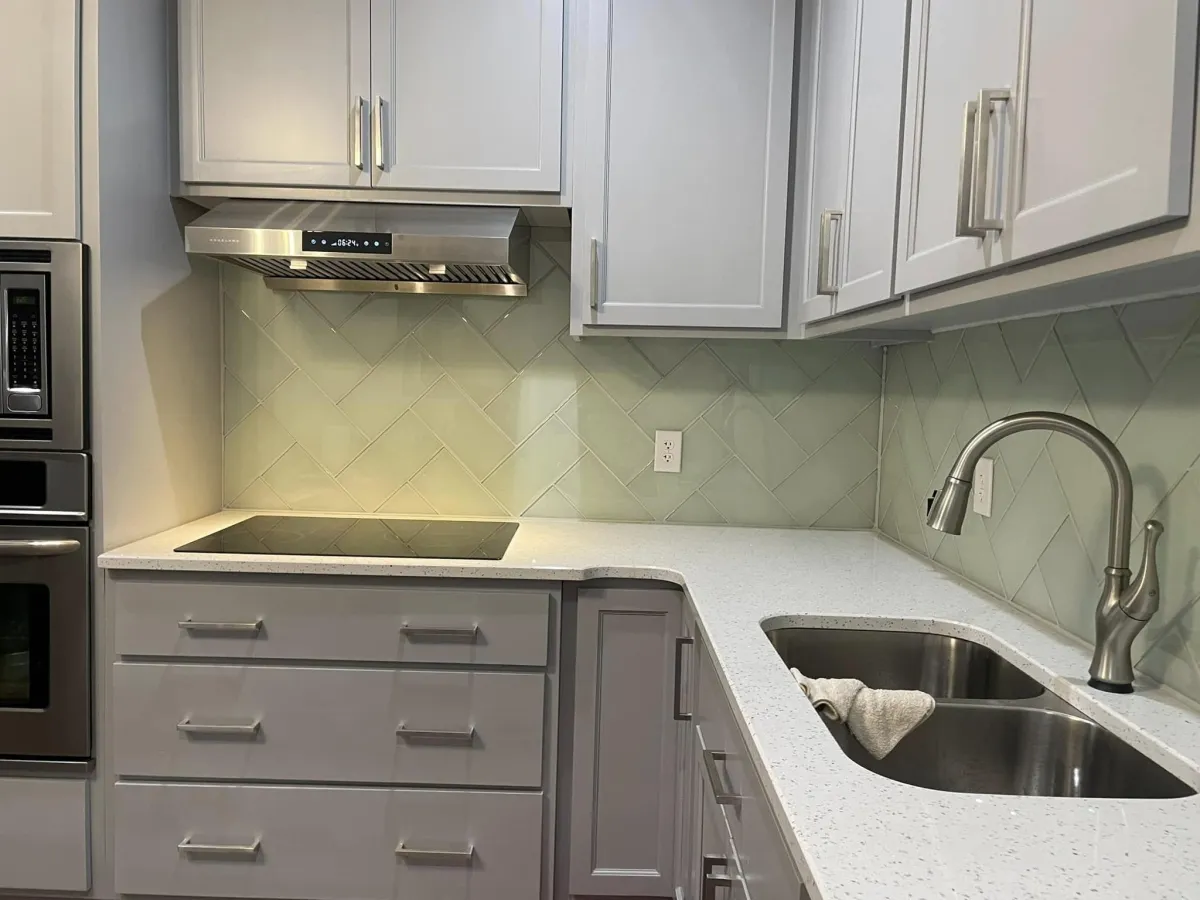 Compact kitchen remodel with white cabinets and quartz counters in Columbia County