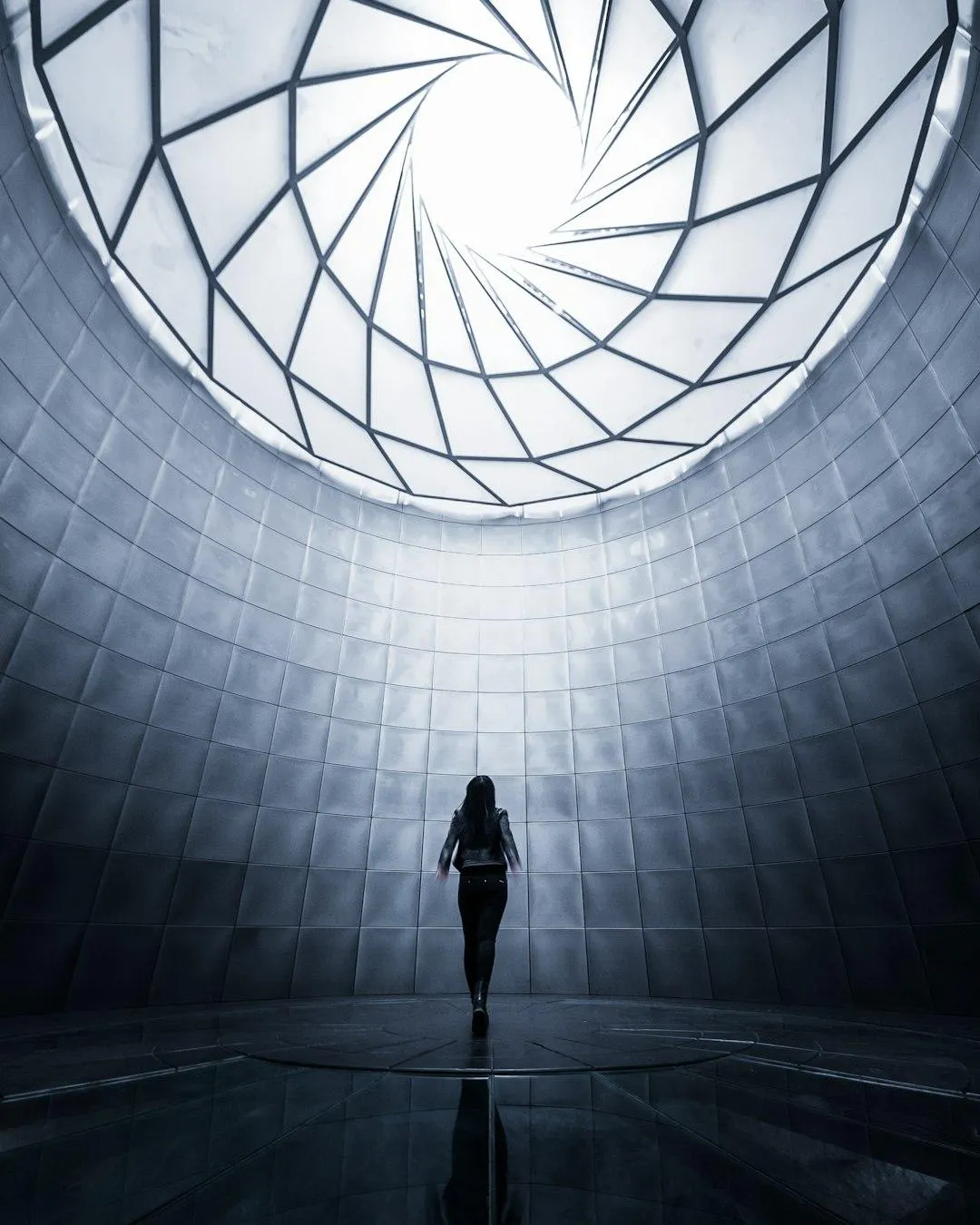 Person standing beneath windows