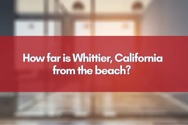 Whittier, California cityscape with the nearby Pacific coastline in the distance under a bright blue sky