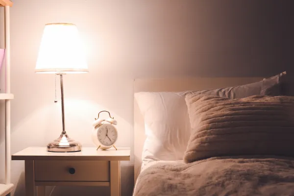 Dim lamp in cozy bedroom