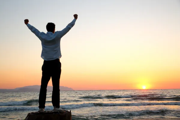 Silhouette of a man embracing the sun.