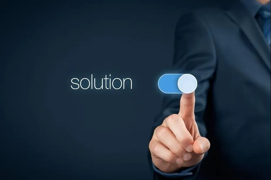 A person's finger is poised to activate a glowing digital toggle switch, with the word 'solution' displayed to the left.