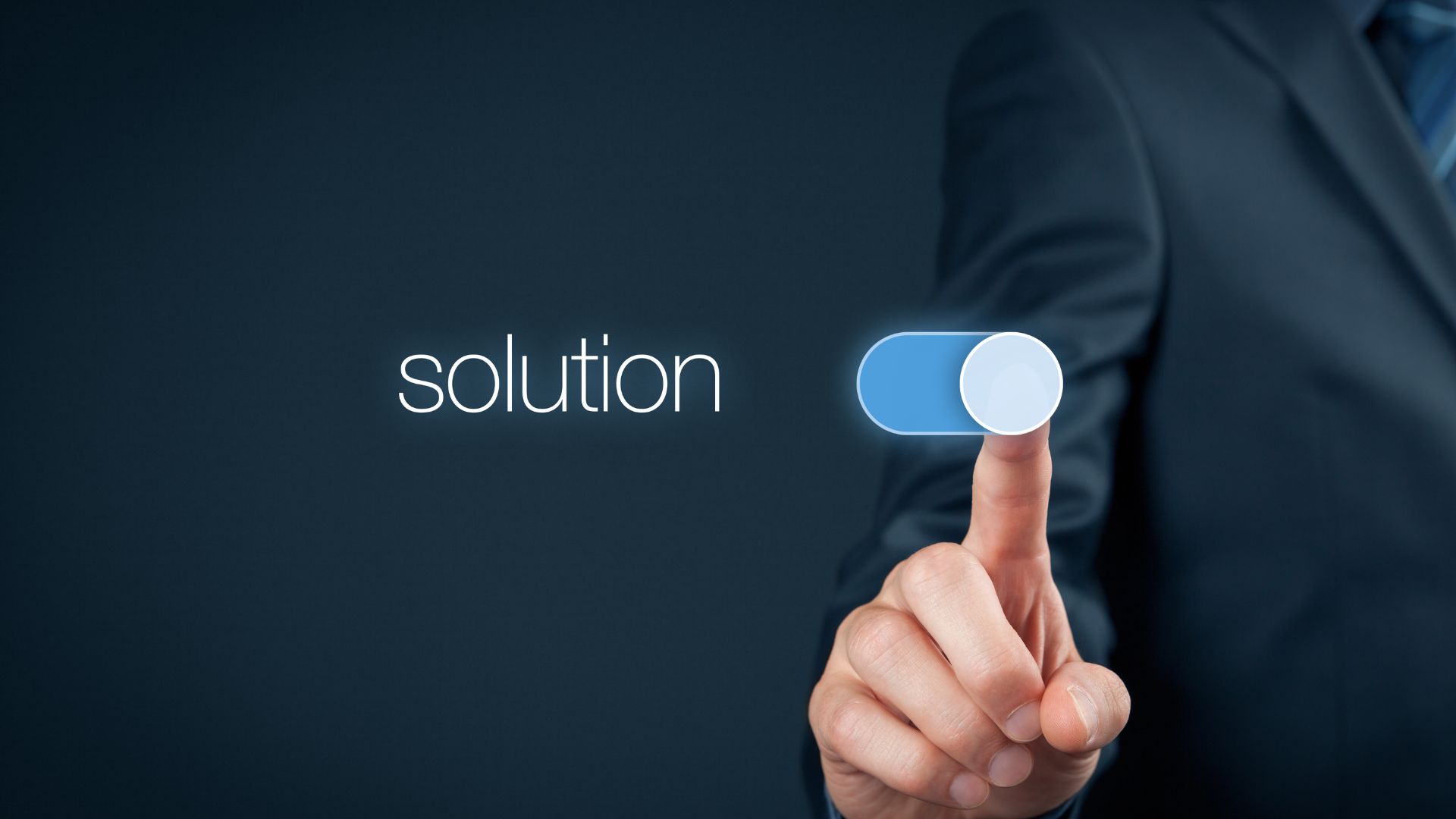 A hand in a business suit activating a digital toggle switch labeled "solution" against a dark blue background.
