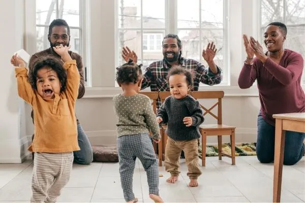 Childcare Staff clapping while children are dancing - Impact of Childcare on Early Language Development