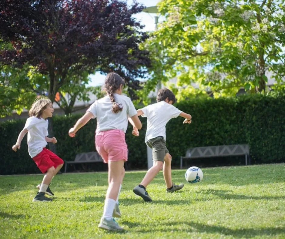 kids playing soccer in the park