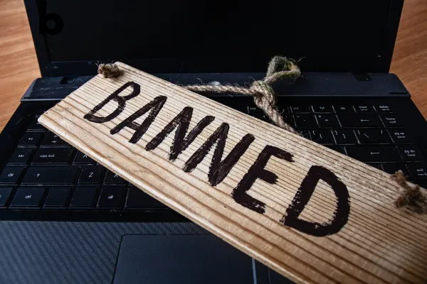 A bold headline reading 'Is TikTok Getting Banned?' overlaid on a collage featuring the TikTok logo, a smartphone, and a person creating content, symbolizing the importance of adapting to social media changes.