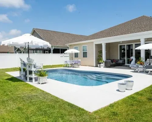 Sudbury Barrier Reef Fiberglass Inground Pool in a backyard in Indianapolis Indiana by Jensen's Pools and More