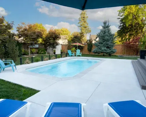 Grande Barrier Reef Fiberglass Inground Pool in a backyard in Indianapolis Indiana by Jensen's Pools and More