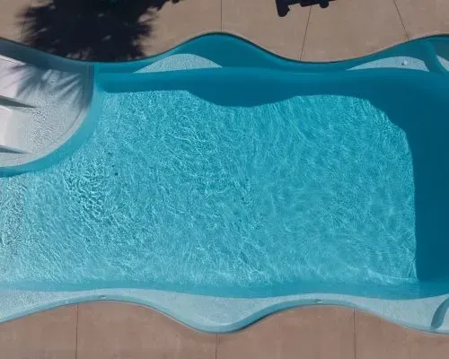 Coral Sea Barrier Reef Fiberglass Inground Pool in a backyard in Indianapolis Indiana by Jensen's Pools and More