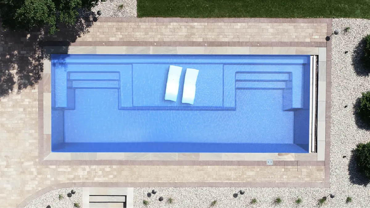 Magnate Thursday Pools Fiberglass Inground Pool in a backyard in Indianapolis Indiana by Jensen's Pools and More