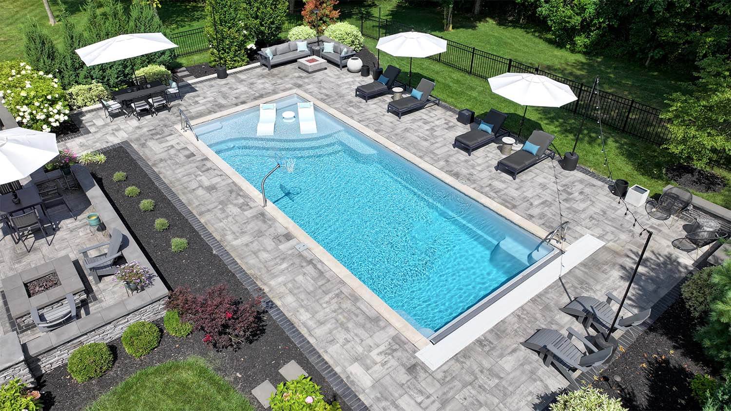Aspen Thursday Pools Fiberglass Inground Pool in a backyard in Indianapolis Indiana by Jensen's Pools and More