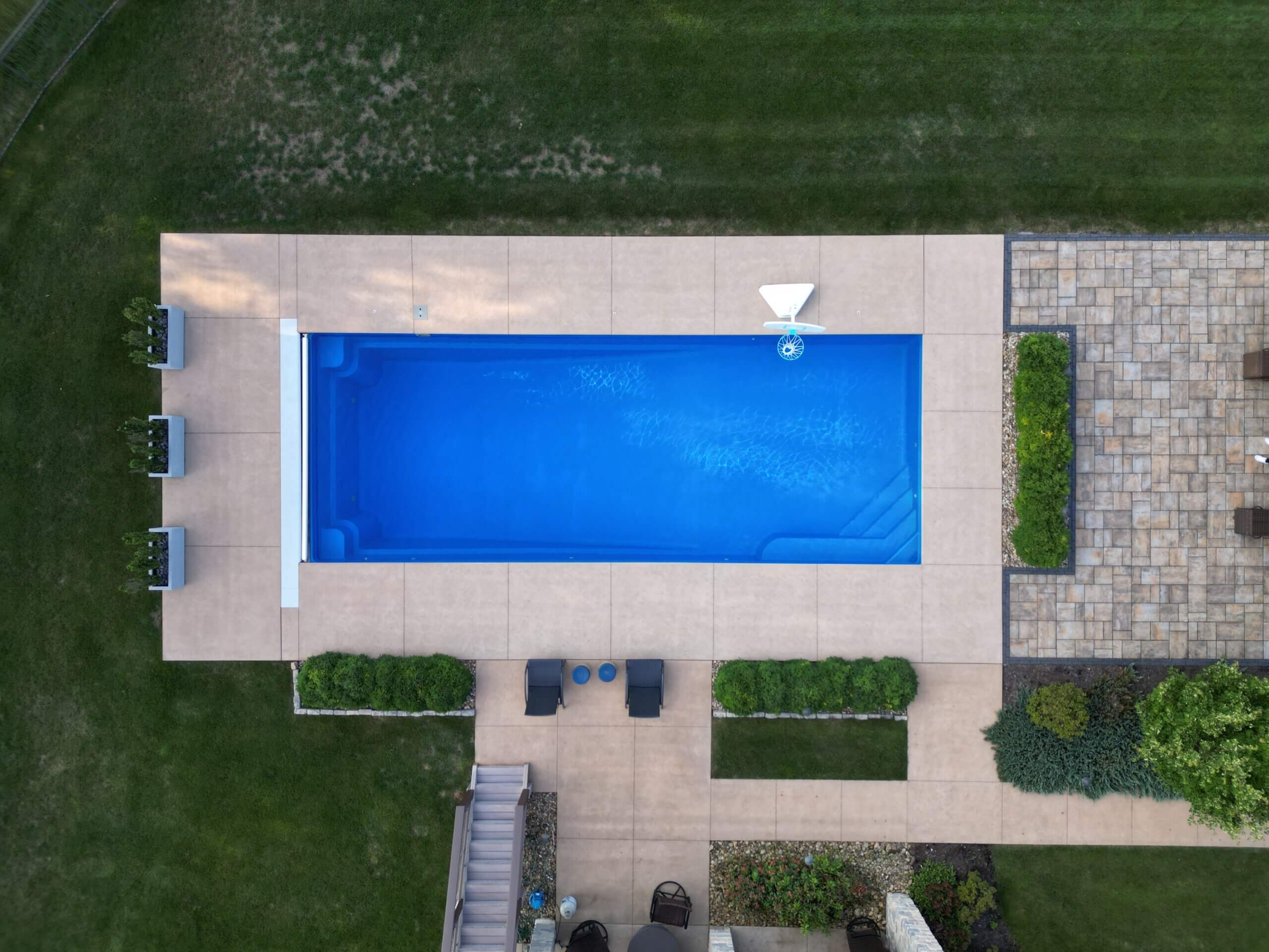 Monolith Thursday Pools Fiberglass Inground Pool in a backyard in Indianapolis Indiana by Jensen's Pools and More