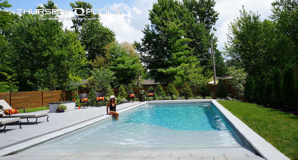 Grace Beach Entry Thursday Pools Fiberglass Inground Pool in a backyard in Indianapolis Indiana by Jensen's Pools and More