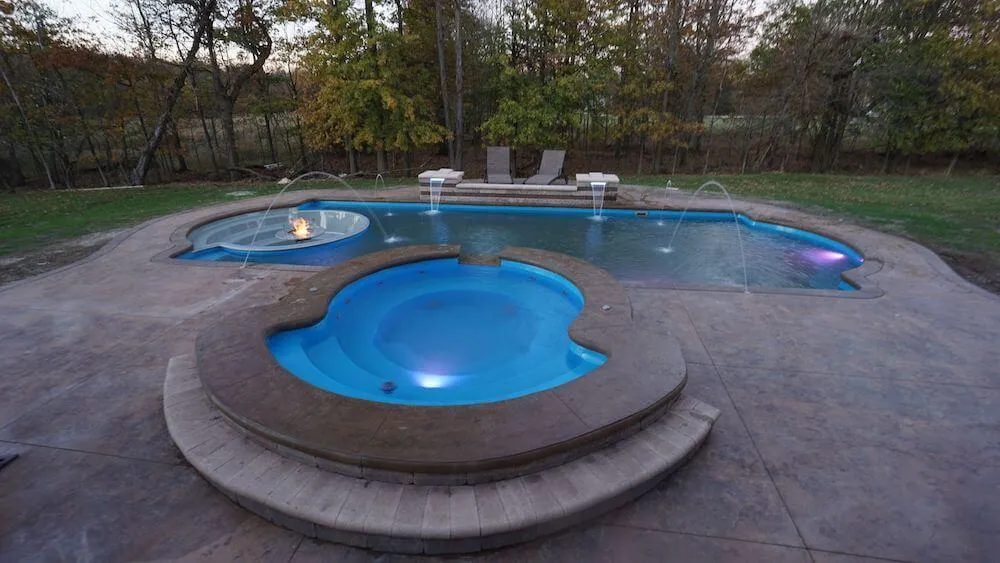 Cortona Sunken Living Area Thursday Pools Fiberglass Inground Pool in a backyard in Indianapolis Indiana by Jensen's Pools and More