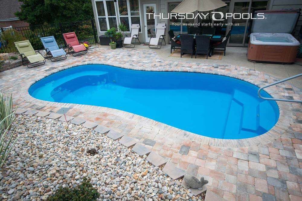 Titus Thursday Pools Fiberglass Inground Pool in a backyard in Indianapolis Indiana by Jensen's Pools and More